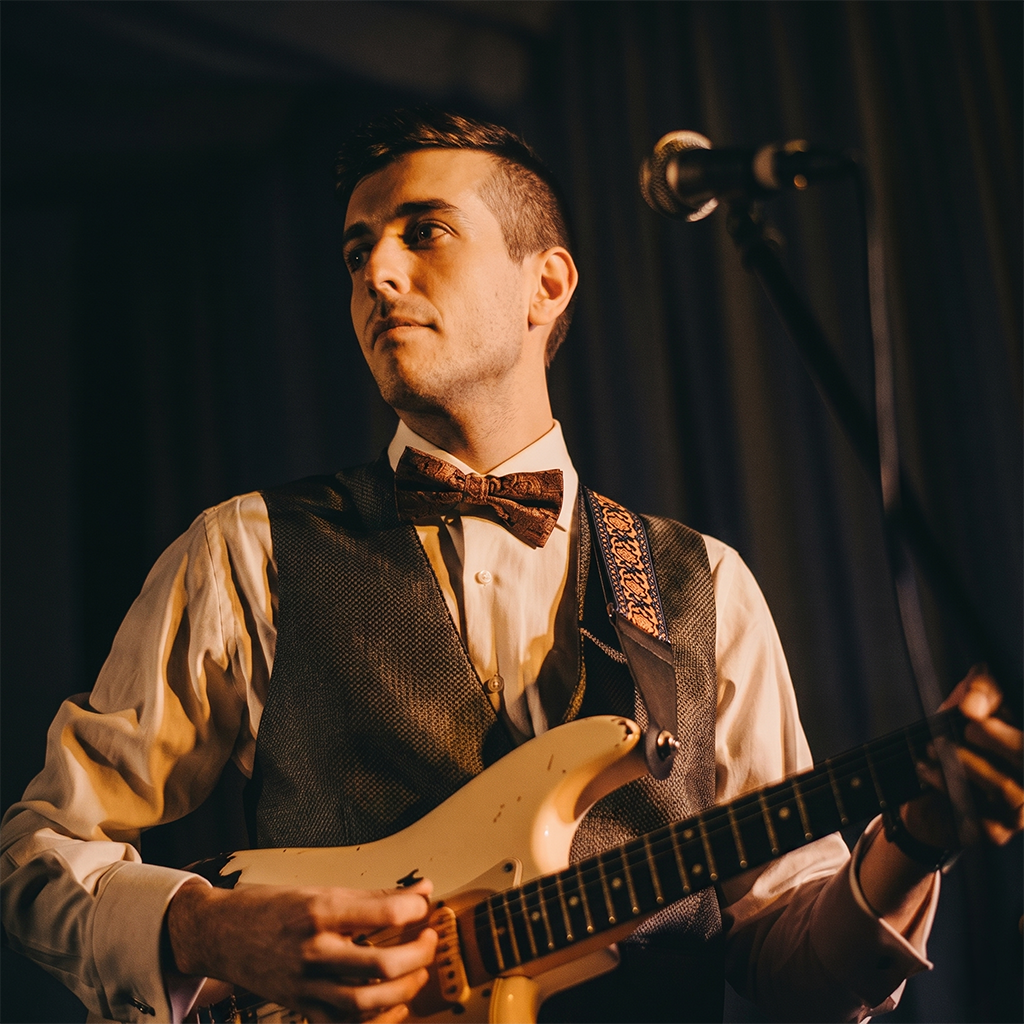 David Pascual playing guitar on stage