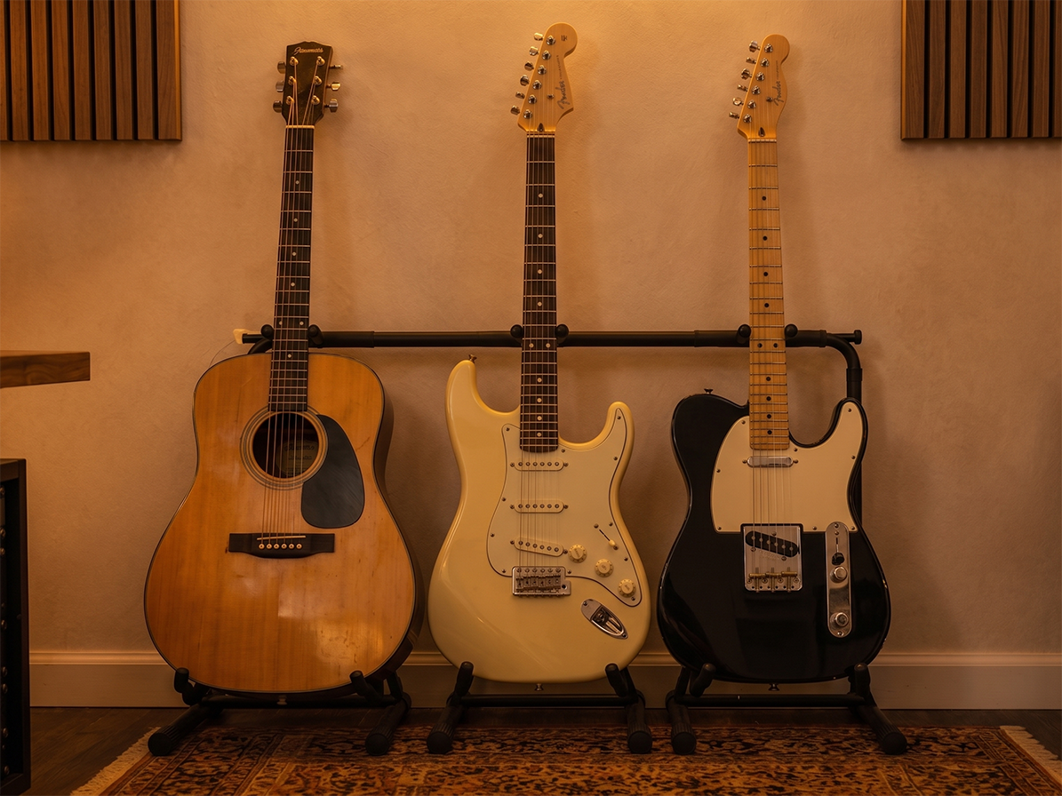Three guitars on stands in the home studio